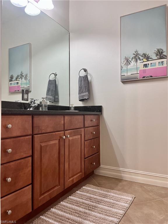 9092 Chula Vista Street, Unit 11003 Naples, FL 34113 - Photo 10 of 42 a spacious bathroom with a sink and a mirror