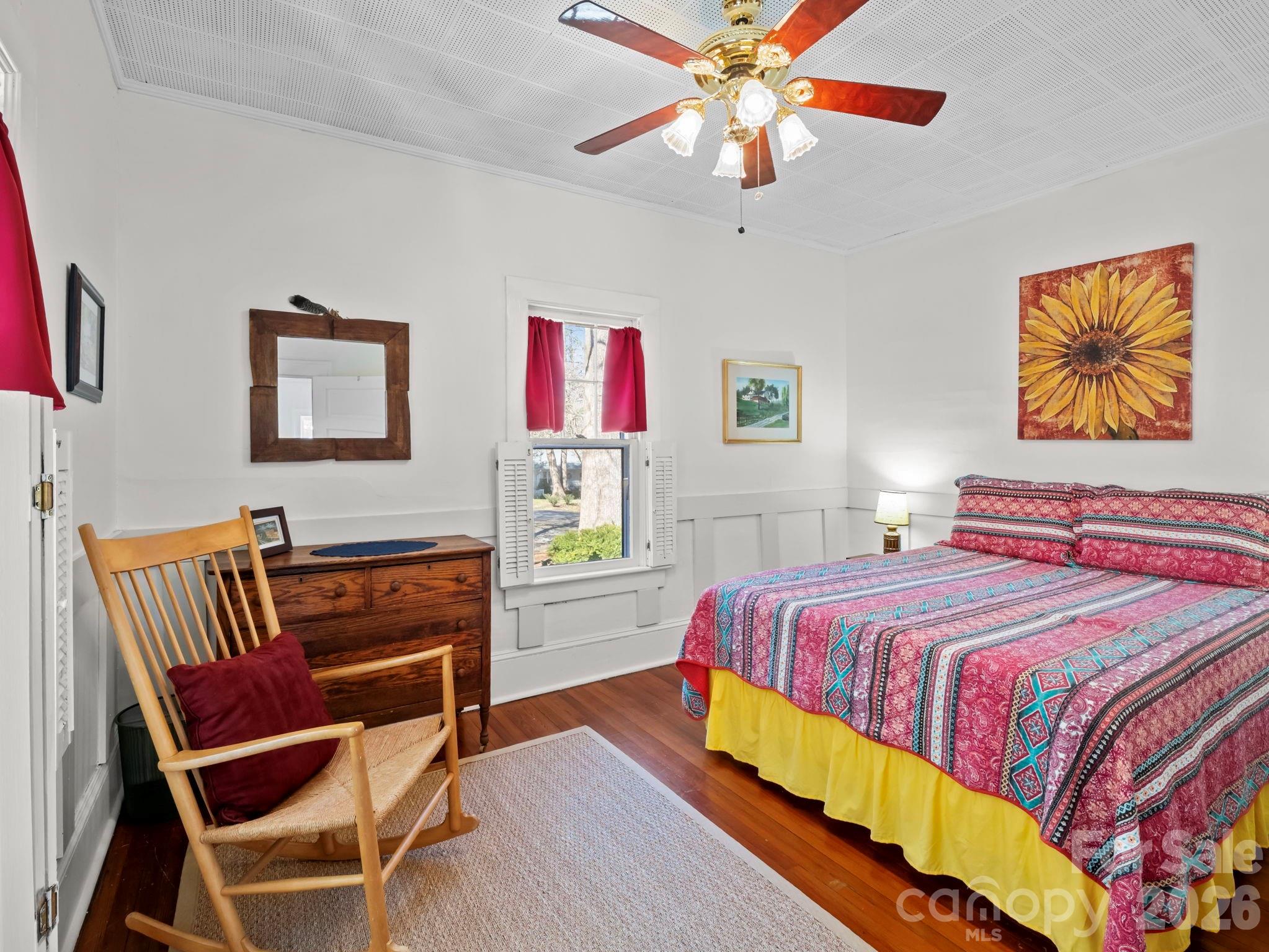 439 Lockhart Road Tryon, NC 28782 - Photo 16 of 43 a bedroom with a bed and wooden floor