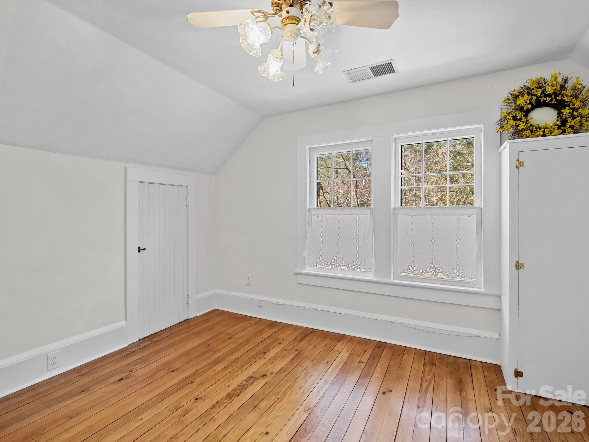 439 Lockhart Road Tryon, NC 28782 - Photo 23 of 43 a view of an empty room with wooden floor and a window