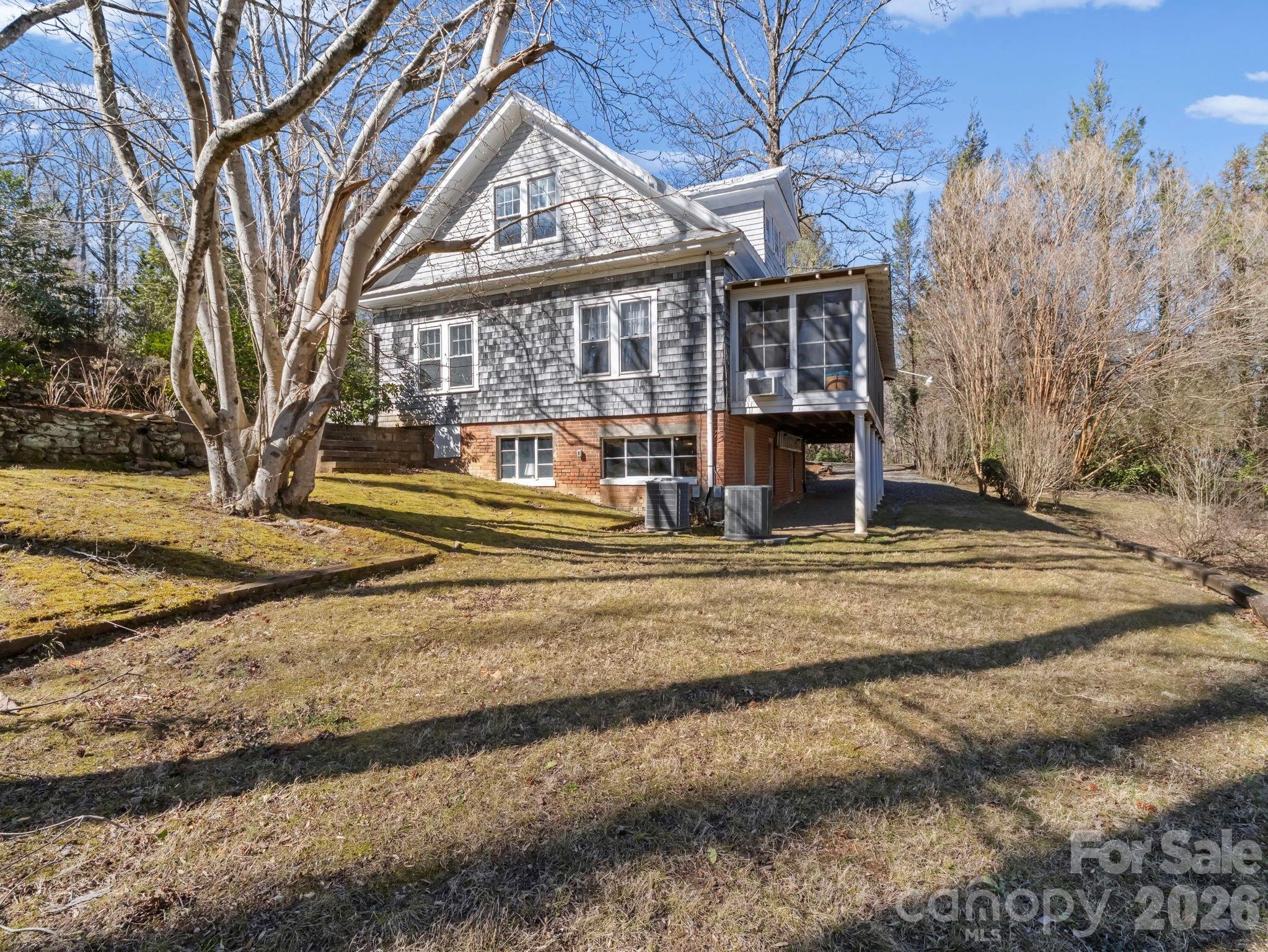439 Lockhart Road Tryon, NC 28782 - Photo 30 of 43 a view of a house with a yard and large trees