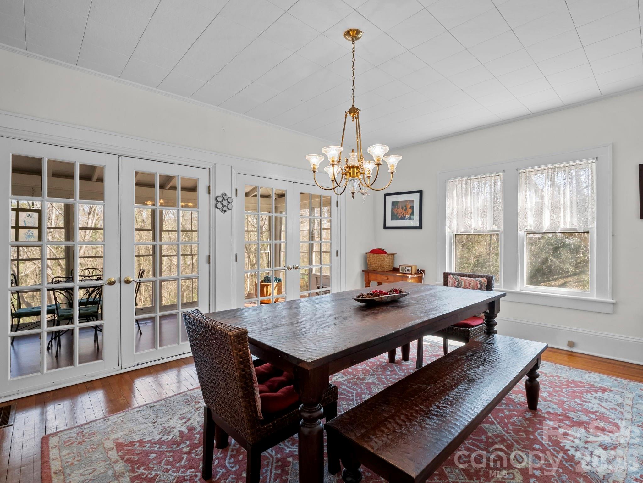 439 Lockhart Road Tryon, NC 28782 - Photo 9 of 43 a view of a dining room with furniture window and wooden floor