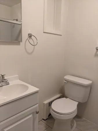 a white toilet sitting next to a bathroom sink