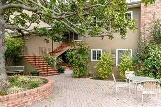 a front view of a house with a garden