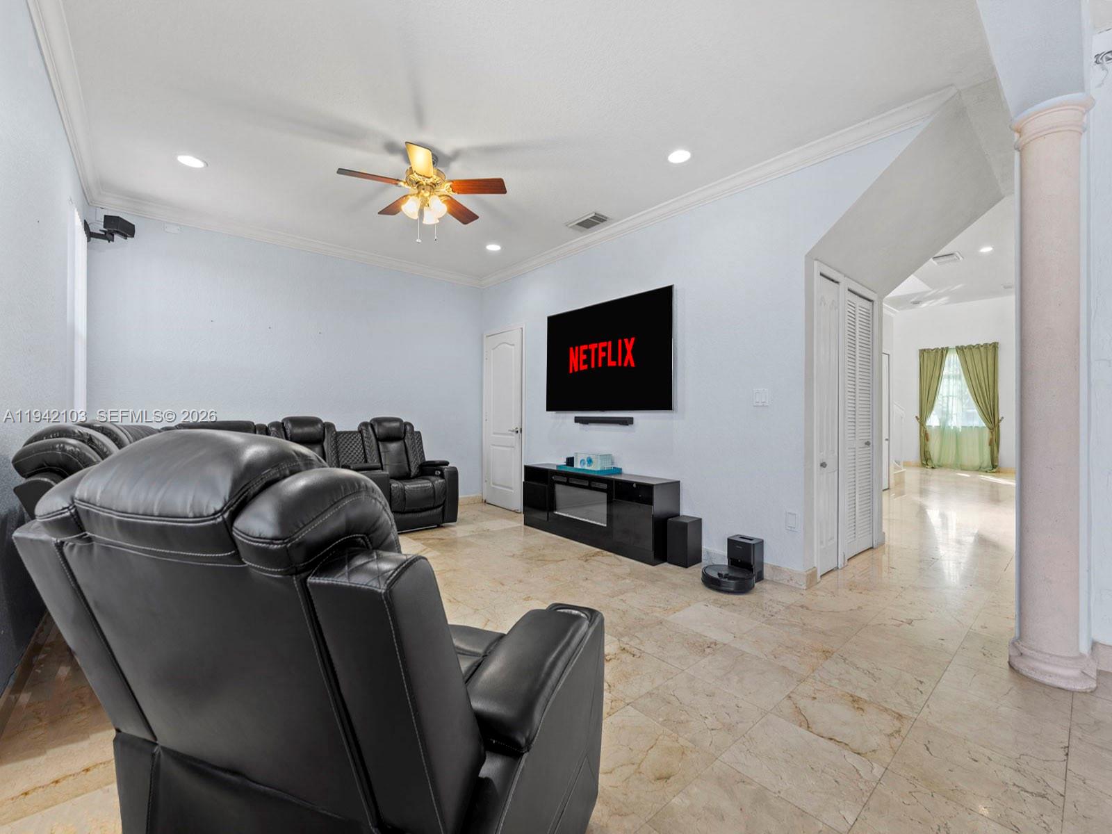16421 Southwest 64th Terrace Miami, FL 33193 - Photo 12 of 45 a living room with furniture a flat screen tv and a chandelier