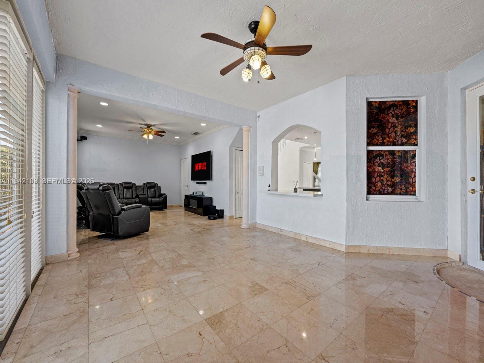 16421 Southwest 64th Terrace Miami, FL 33193 - Photo 15 of 45 a view of a livingroom with furniture and a ceiling fan