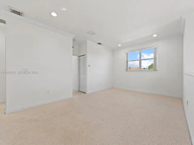 an empty room with windows and closet