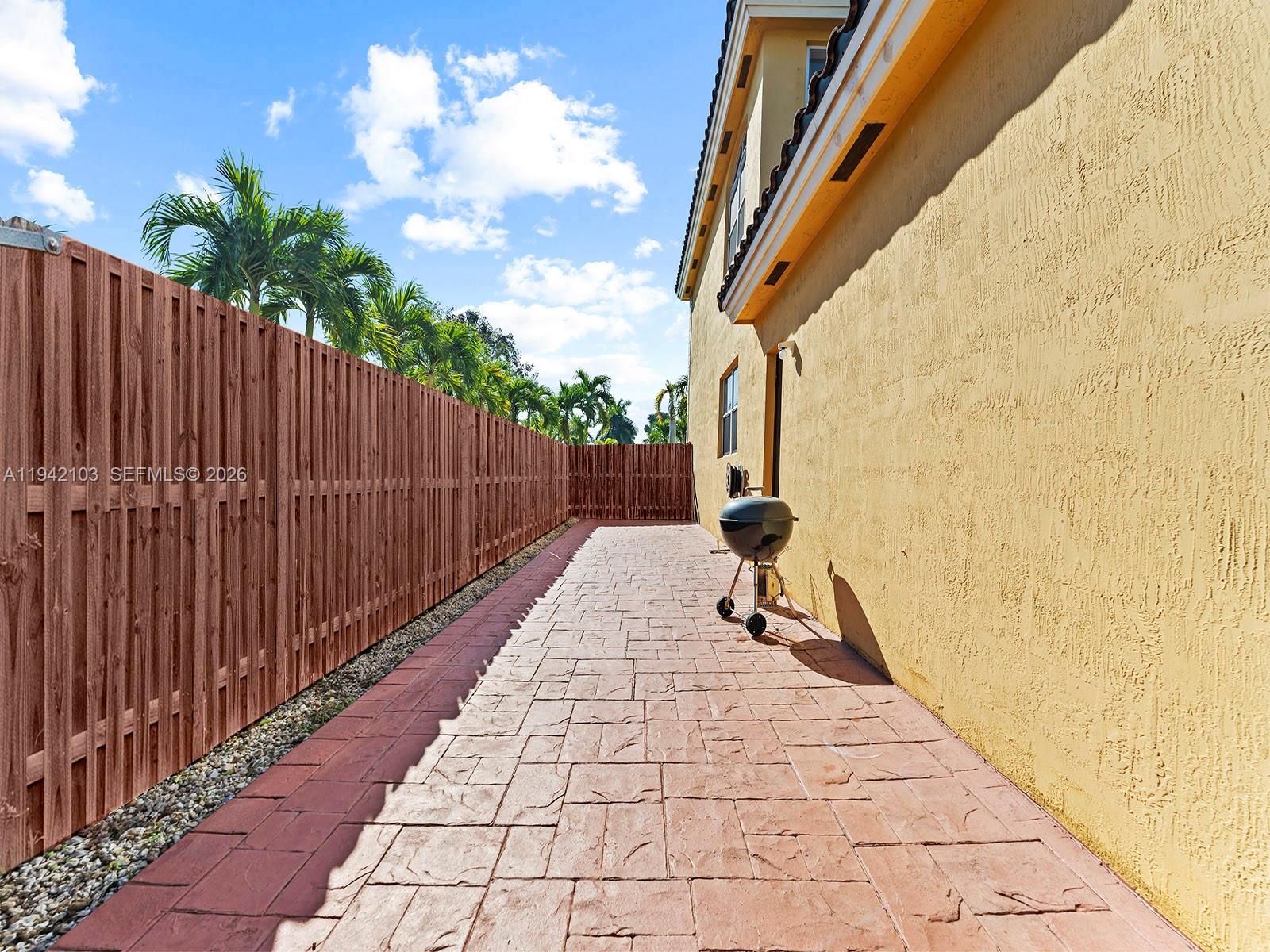 16421 Southwest 64th Terrace Miami, FL 33193 - Photo 38 of 45 a view of a pathway with a wrought fence