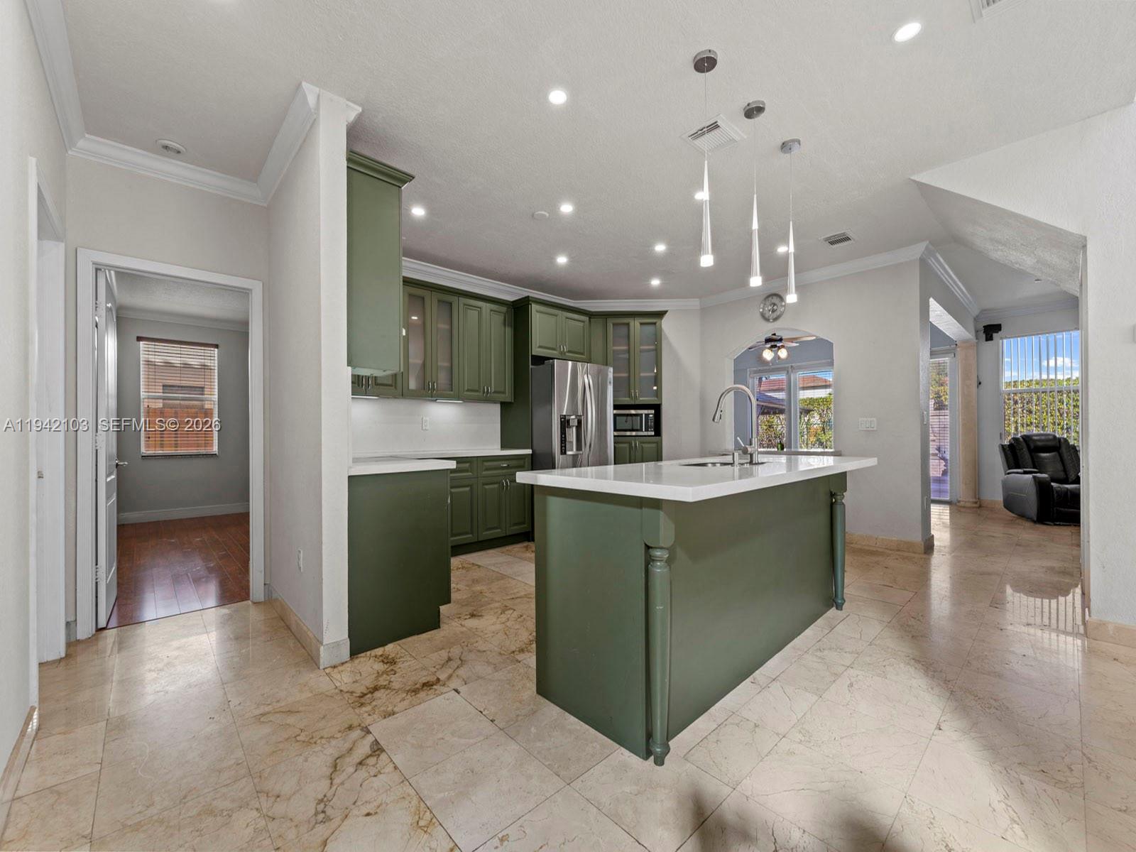 16421 Southwest 64th Terrace Miami, FL 33193 - Photo 5 of 45 a kitchen with kitchen island a sink stainless steel appliances and cabinets