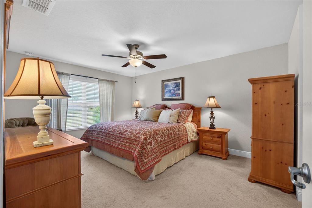 2429 Twin Lake View Road Winter Haven, FL 33881 - Photo 23 of 37 a spacious bedroom with a bed and a window
