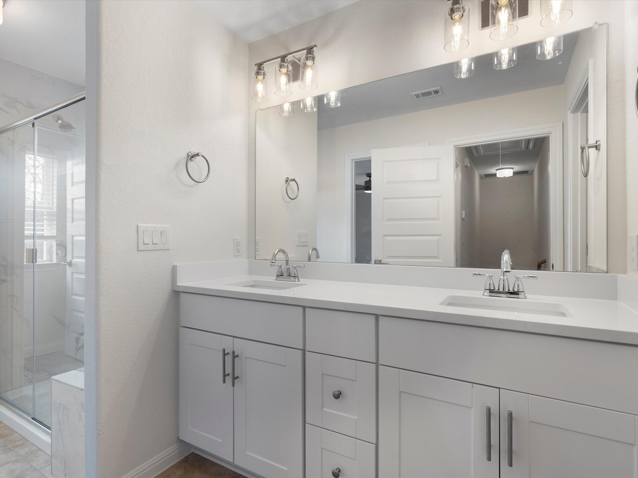 21007 Coleman Branch Creek Road Manor, TX 78653 - Photo 26 of 31 Primary bathroom with dual vanity and modern finishes.
