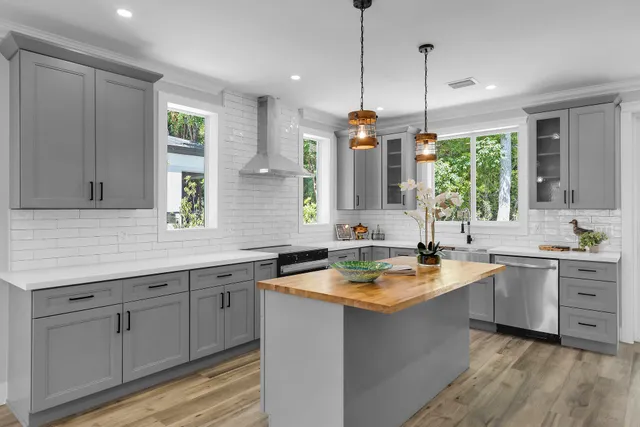 a kitchen with a sink stove and cabinets