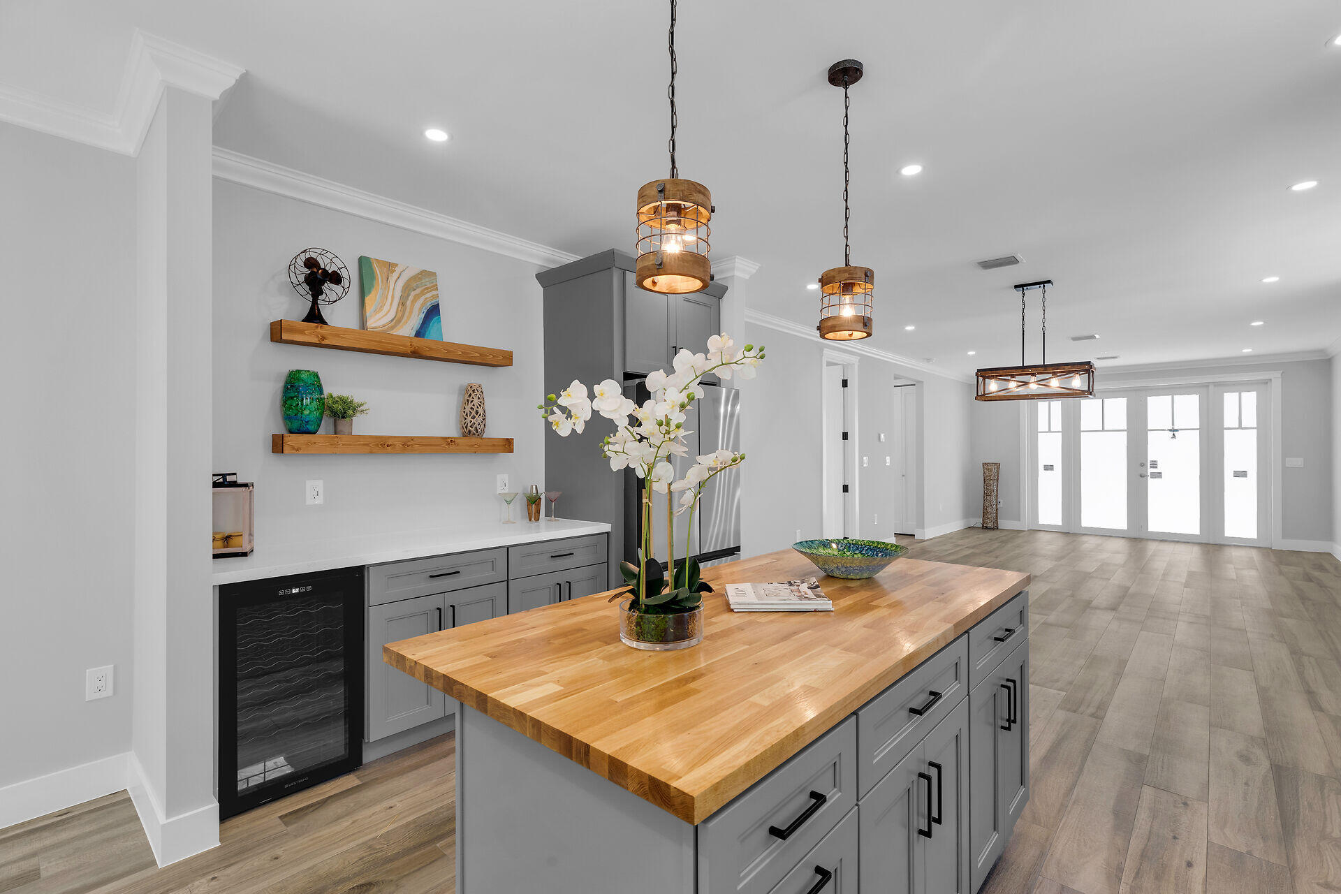 68 Coral Way Key Largo, FL 33037 - Photo 13 of 31 a room with kitchen island a chandelier and wooden floor