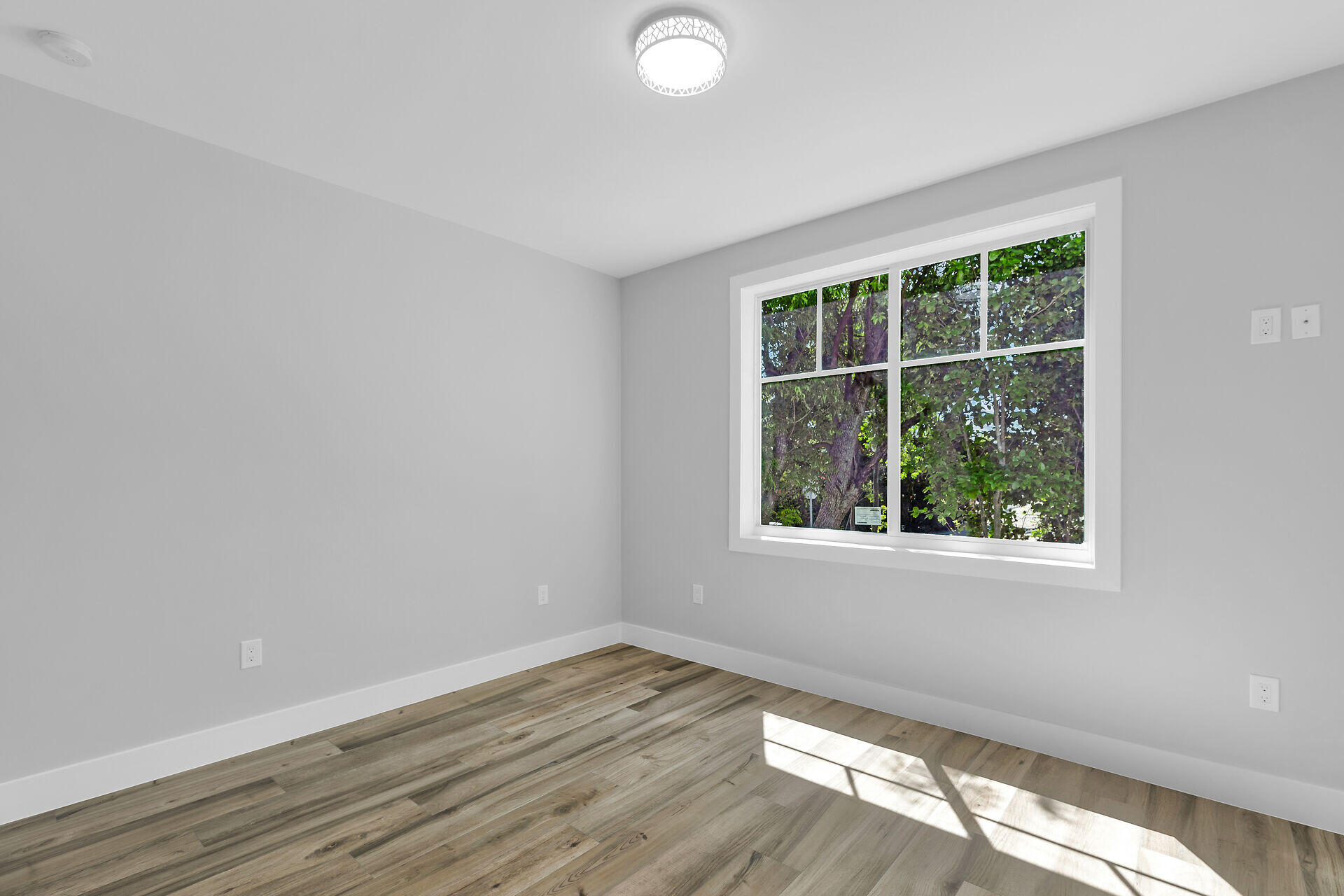 68 Coral Way Key Largo, FL 33037 - Photo 17 of 31 an empty room with wooden floor and windows