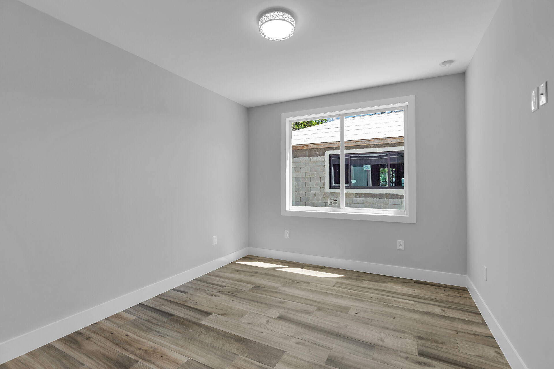 68 Coral Way Key Largo, FL 33037 - Photo 20 of 31 wooden floor in an empty room with a window