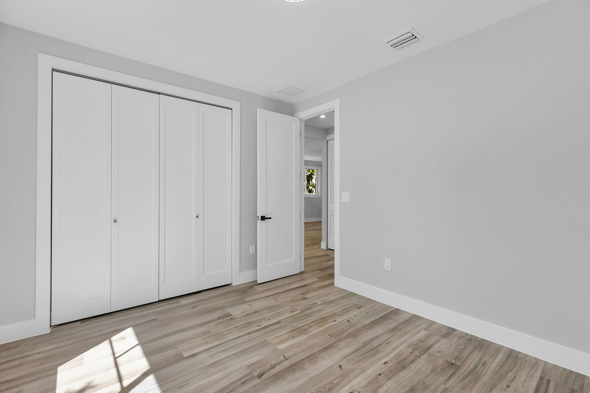 68 Coral Way Key Largo, FL 33037 - Photo 21 of 31 a view of an empty room and wooden floor