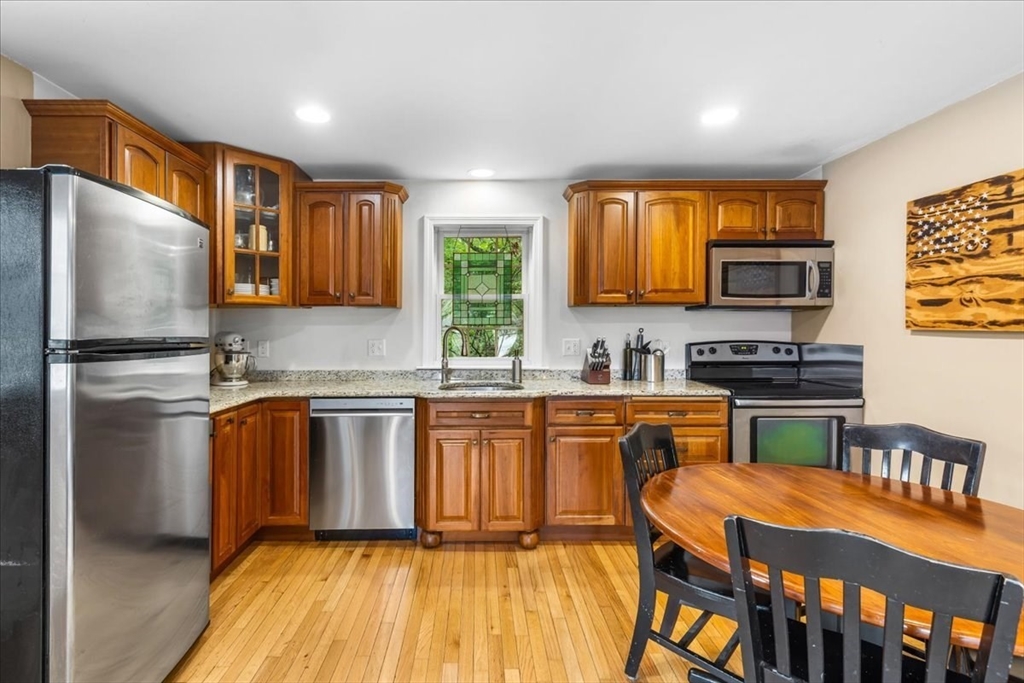 20 Cooks Lane Bellingham, MA 02019 - Photo 8 of 21 a kitchen with stainless steel appliances granite countertop a refrigerator a stove top oven a sink and dishwasher