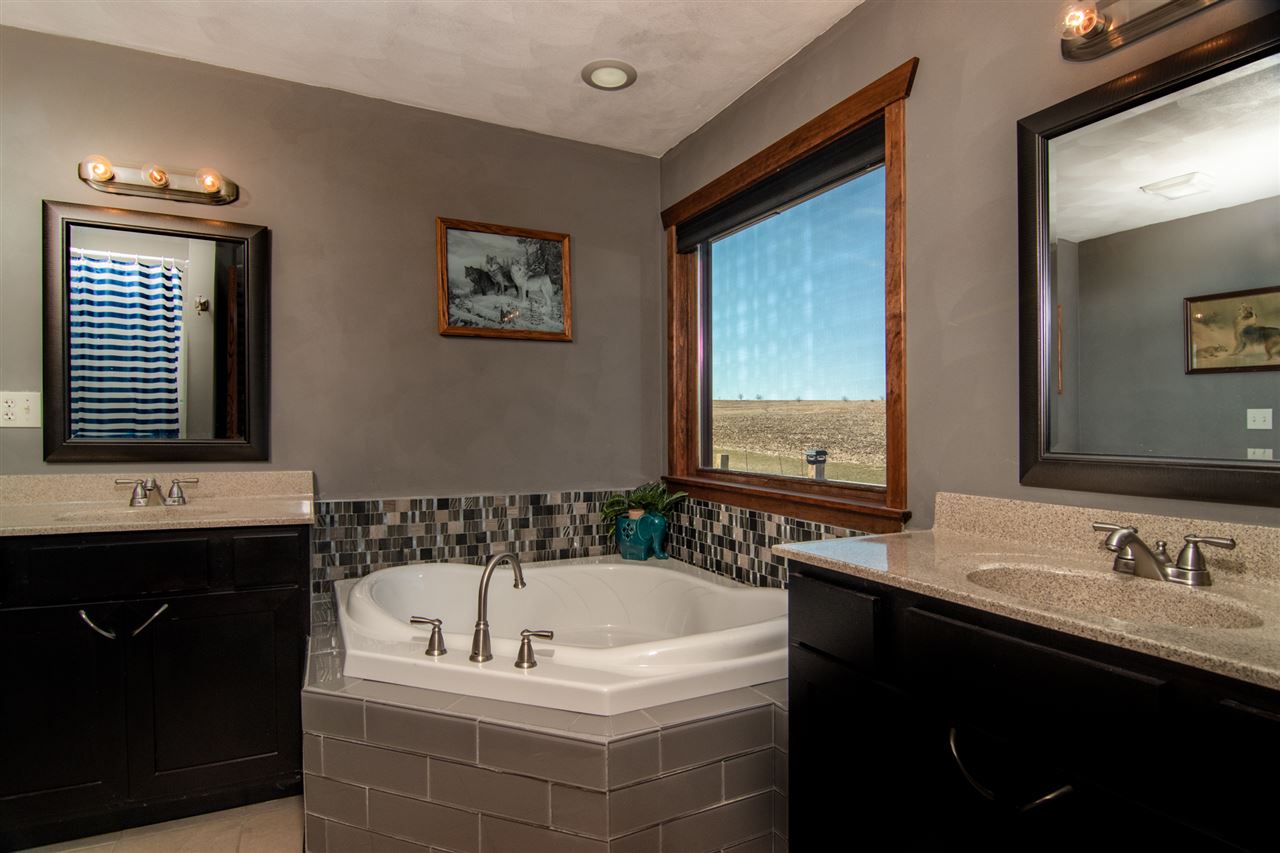 10024 Wheeler Road Durand, IL 61024 - Photo 14 of 25 a bathroom with a tub a sink and mirror
