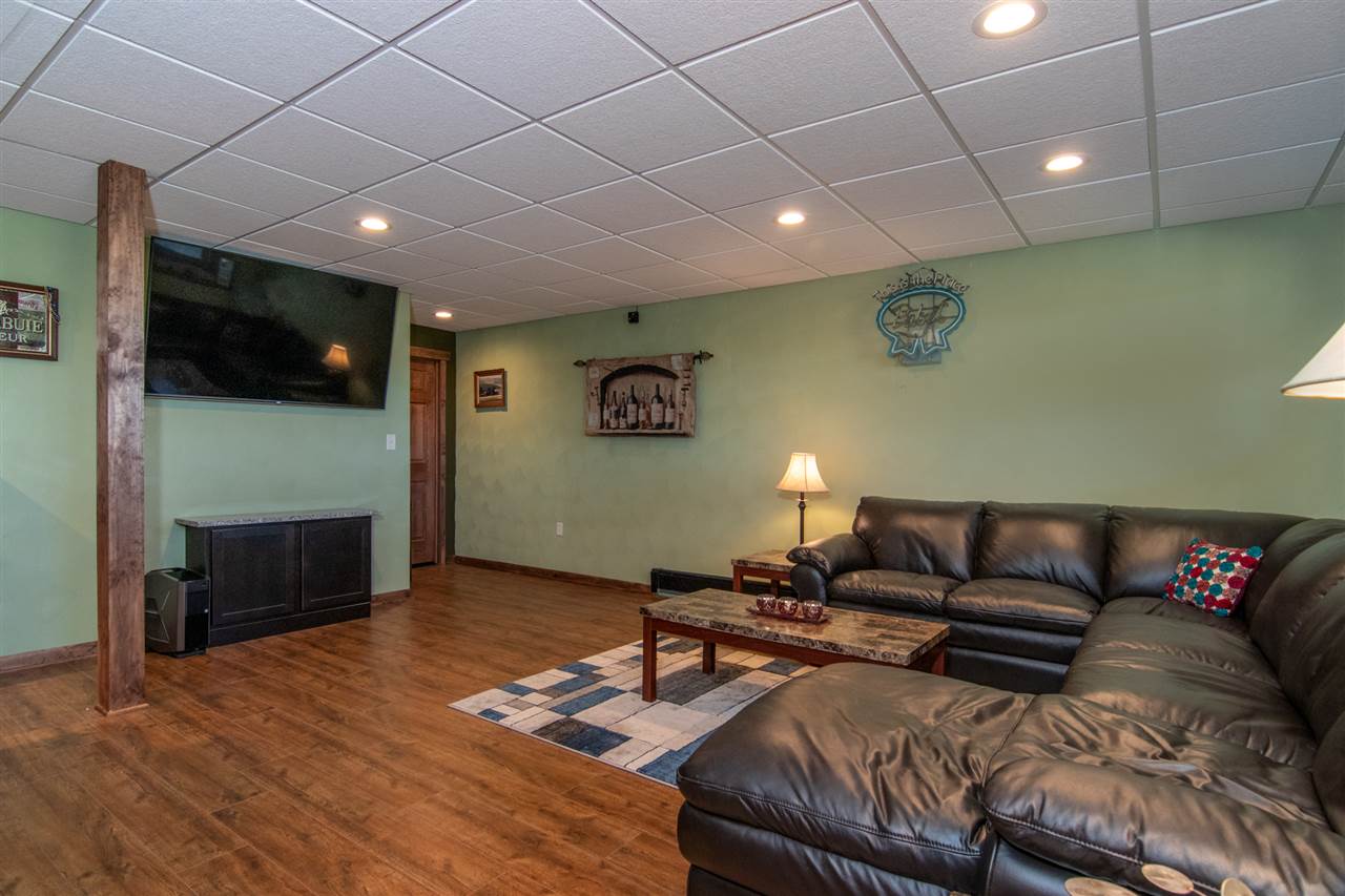 10024 Wheeler Road Durand, IL 61024 - Photo 24 of 25 a living room with furniture a flat screen tv and a fireplace