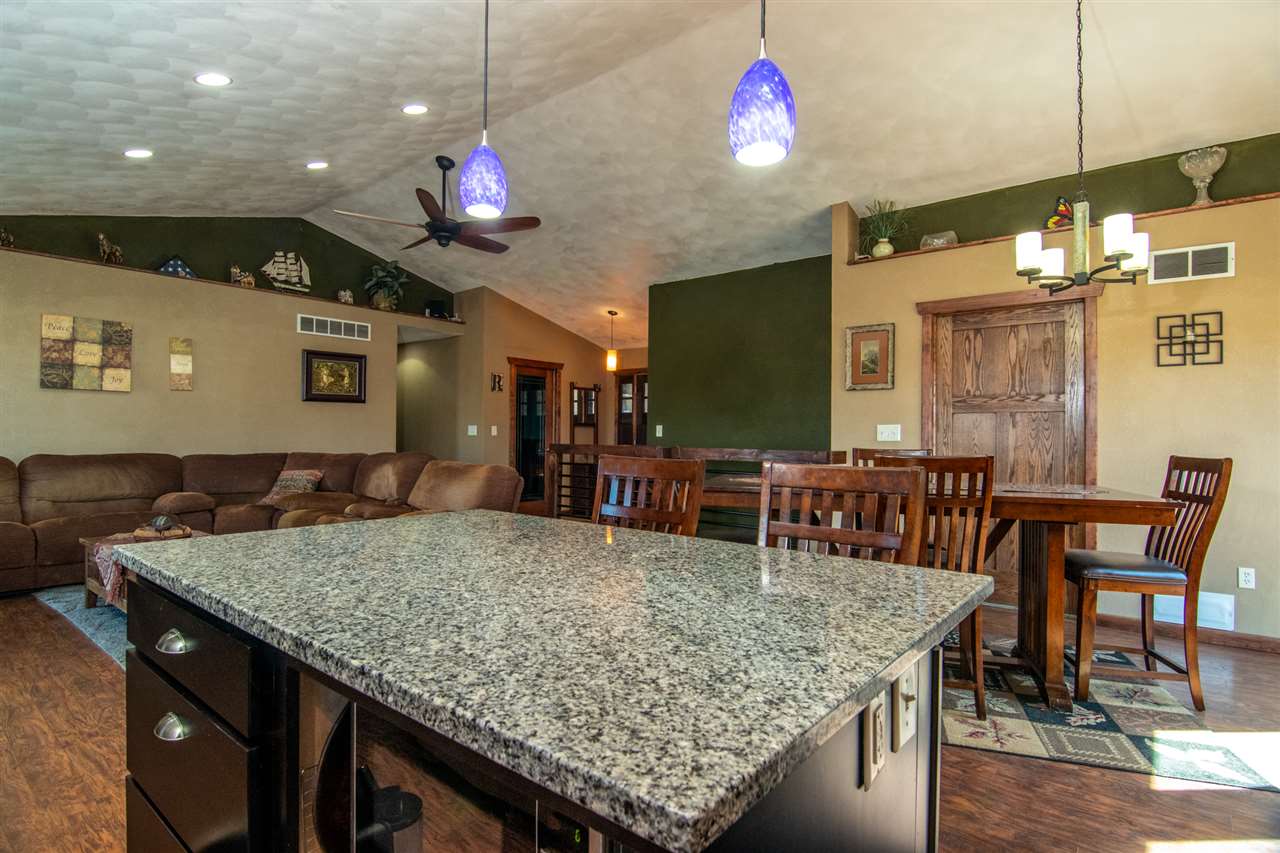 10024 Wheeler Road Durand, IL 61024 - Photo 6 of 25 a kitchen with kitchen island a sink dining table and chairs