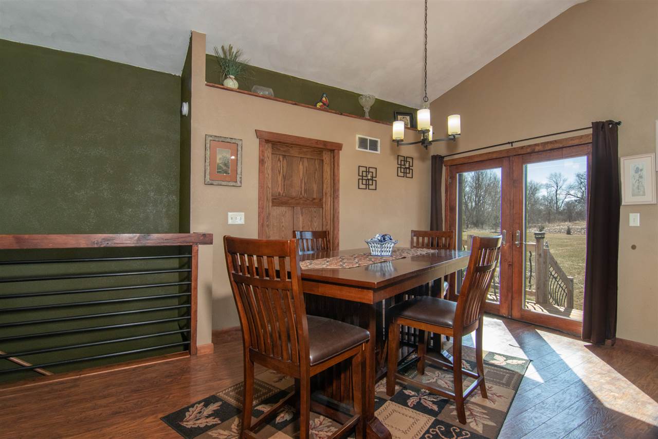 10024 Wheeler Road Durand, IL 61024 - Photo 8 of 25 a view of a dining room with furniture window and wooden floor
