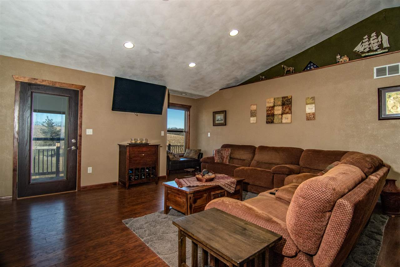 10024 Wheeler Road Durand, IL 61024 - Photo 10 of 25 a living room with furniture and a flat screen tv