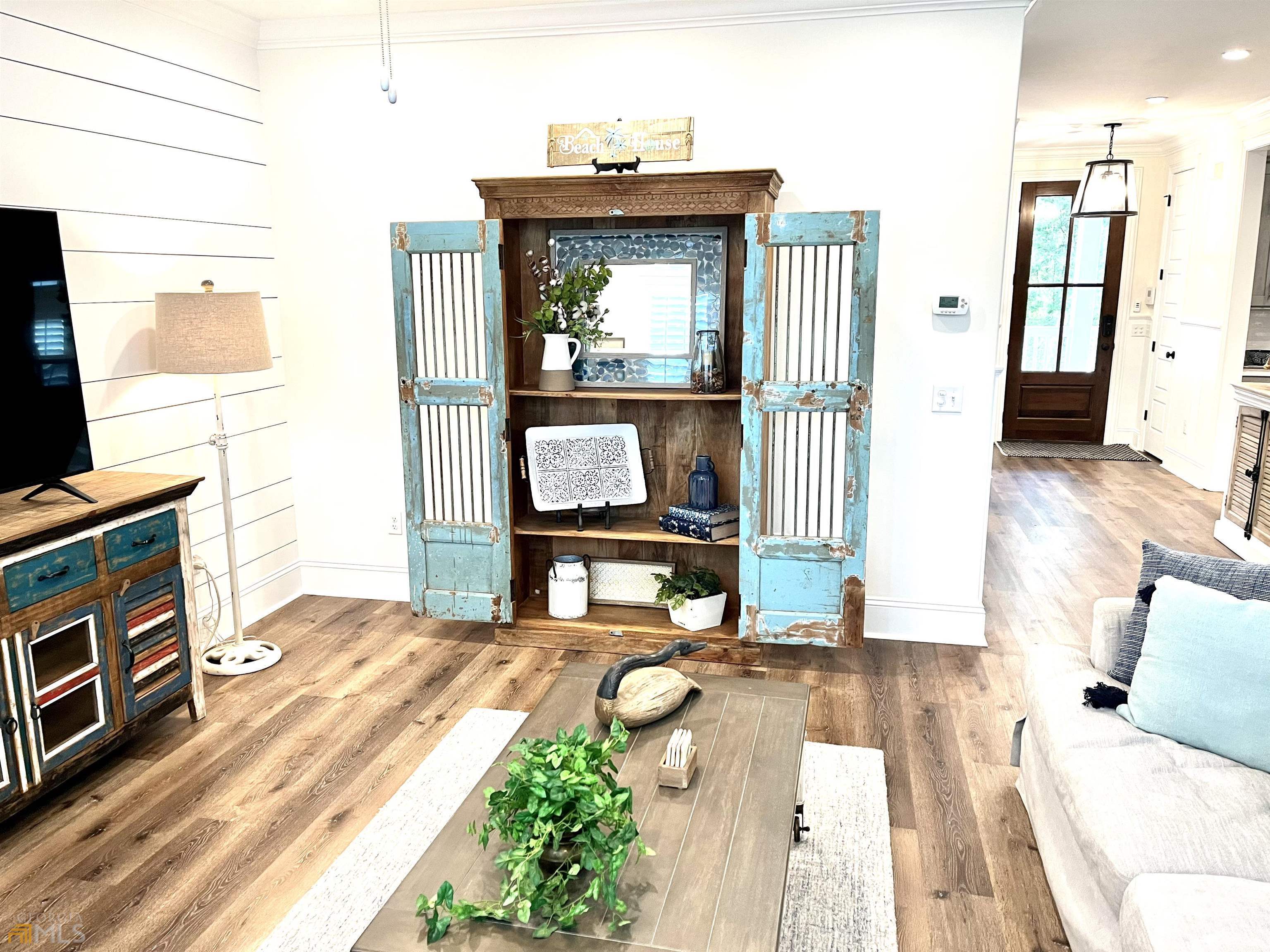 1548 Ocean Boulevard St. Simons, GA 31522 - Photo 14 of 64 a living room with a couch and a flat screen tv
