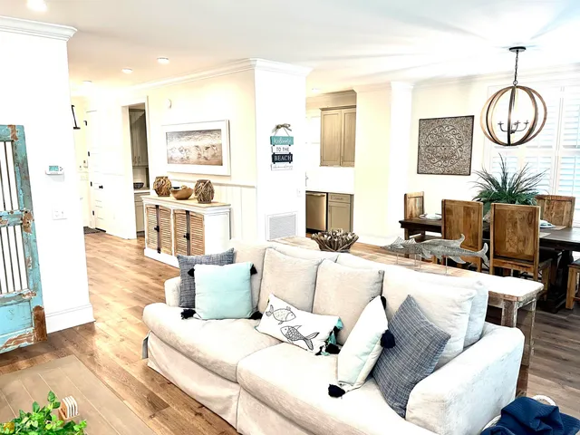 a living room with furniture and a chandelier