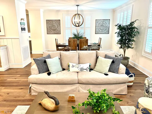 a view of a living room with furniture and wooden floor