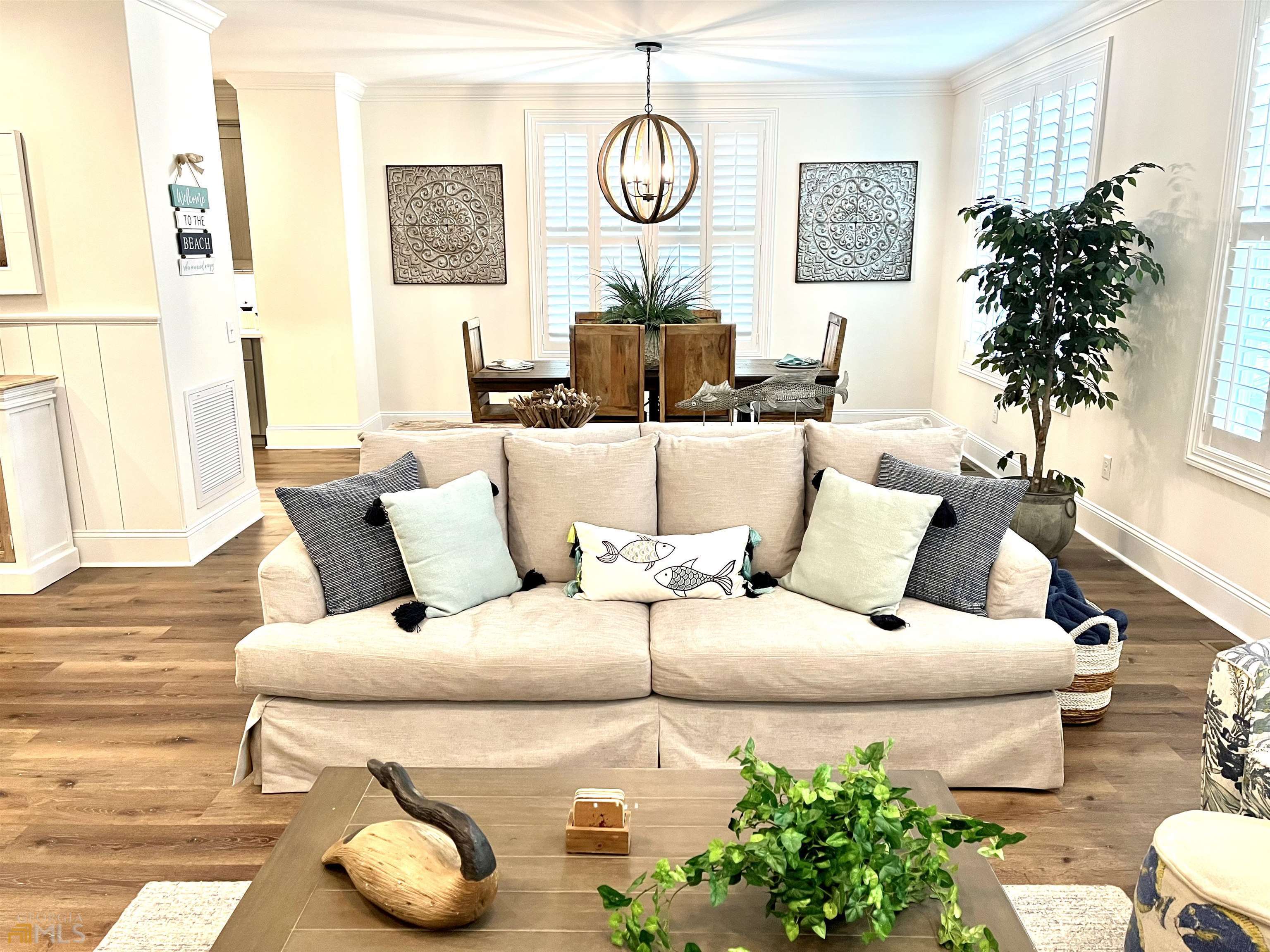 1548 Ocean Boulevard St. Simons, GA 31522 - Photo 20 of 64 a living room with furniture and a chandelier