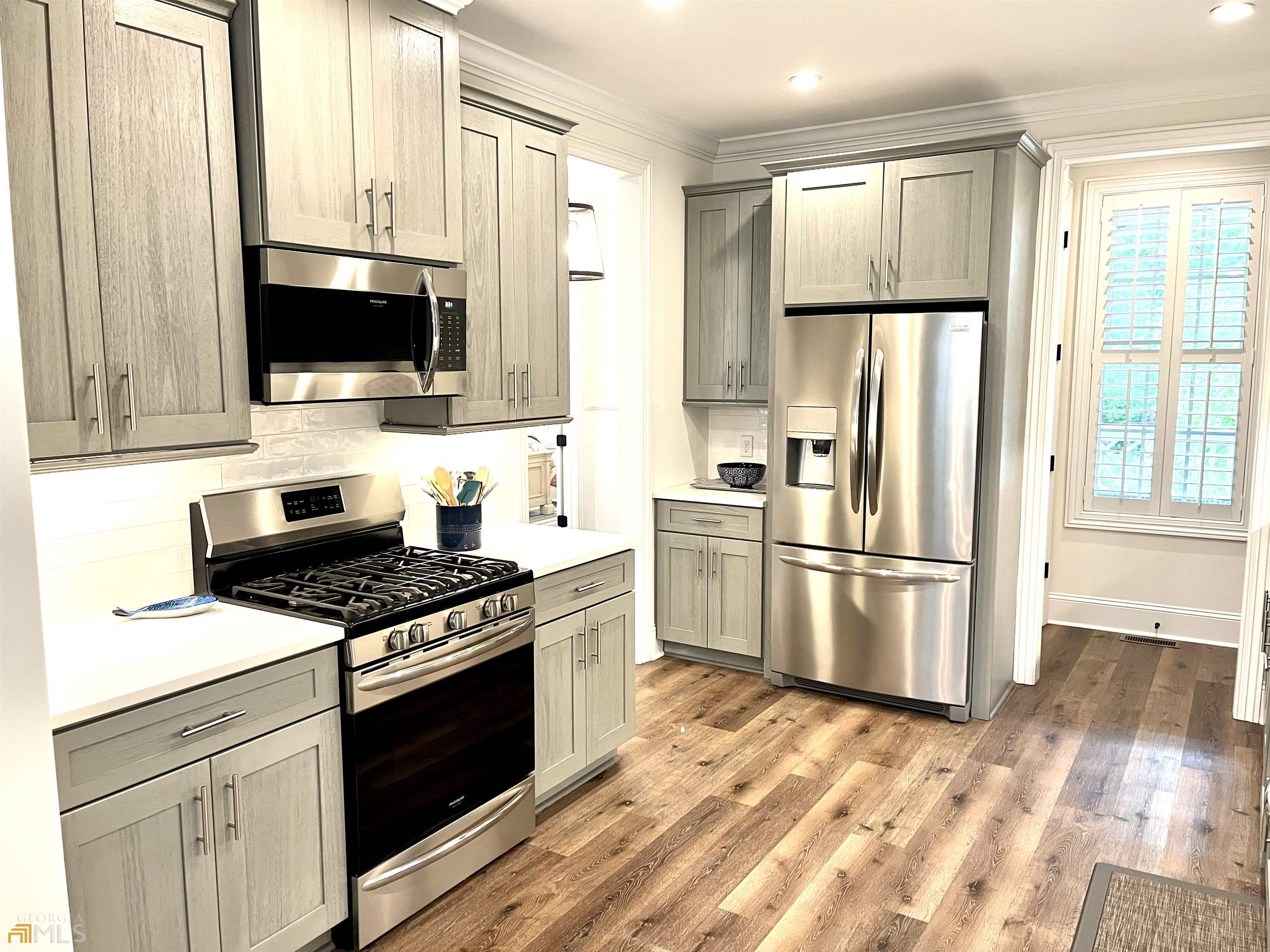 1548 Ocean Boulevard St. Simons, GA 31522 - Photo 24 of 64 a kitchen with stainless steel appliances a refrigerator stove and microwave
