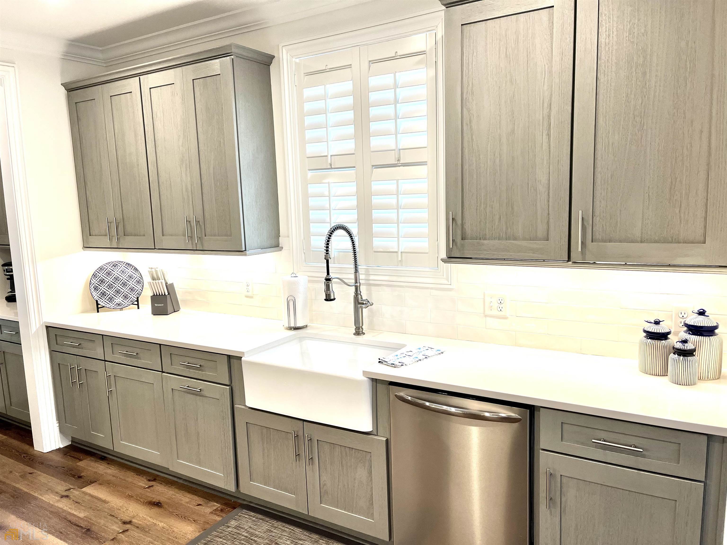 1548 Ocean Boulevard St. Simons, GA 31522 - Photo 26 of 64 a kitchen with a sink cabinets and window