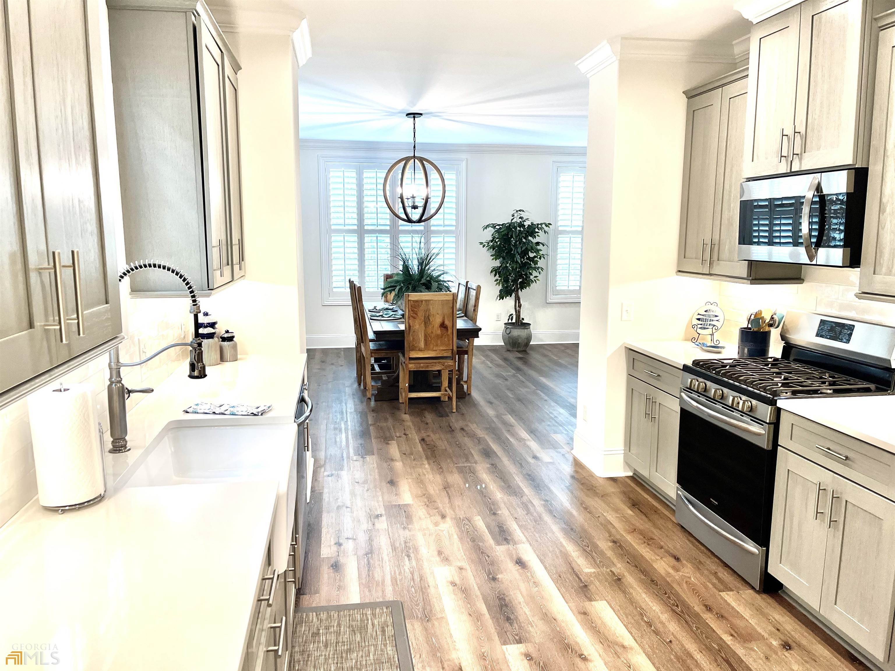 1548 Ocean Boulevard St. Simons, GA 31522 - Photo 28 of 64 a living room with stainless steel appliances granite countertop furniture a fireplace and a flat screen tv