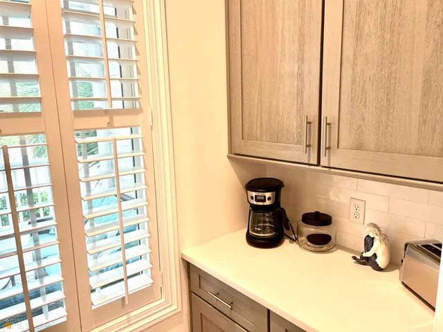 a kitchen with a sink cabinets and a window