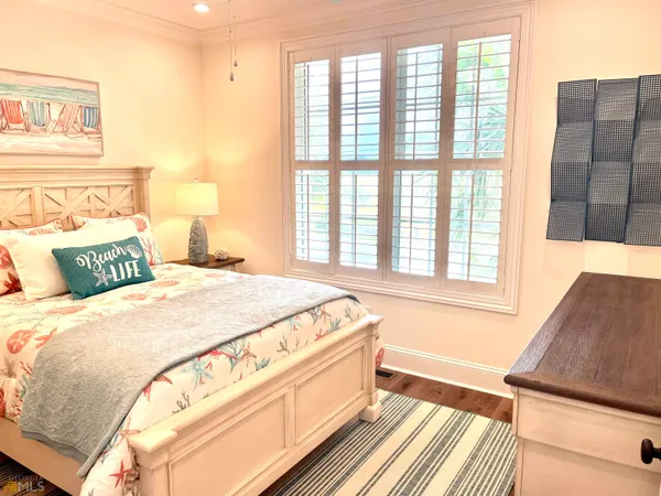 a bedroom with a bed and flat screen tv