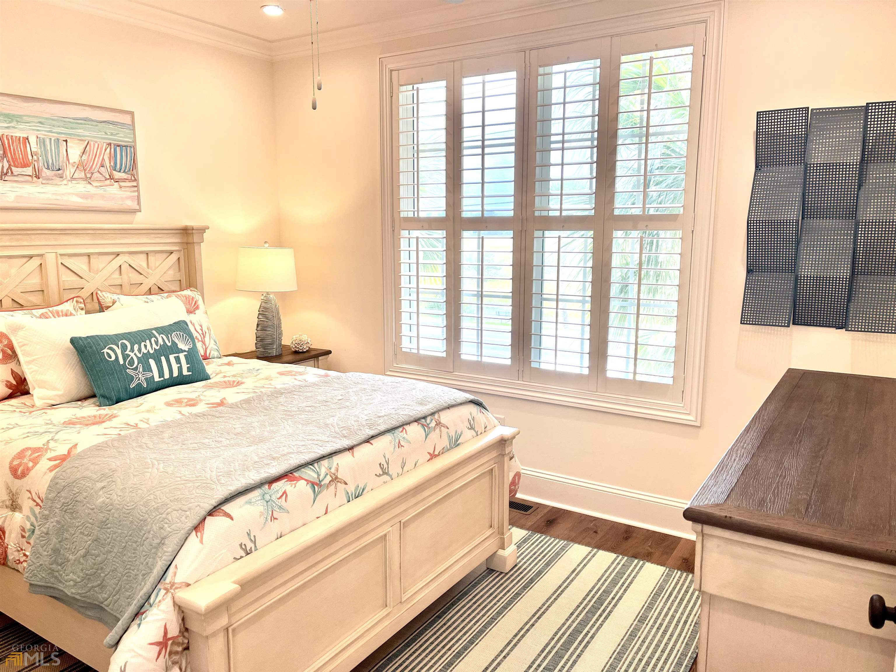 1548 Ocean Boulevard St. Simons, GA 31522 - Photo 32 of 64 a spacious bedroom with a bed and wooden floor
