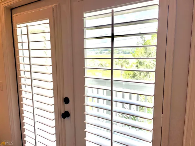 a bedroom with two beds and a painting on the wall