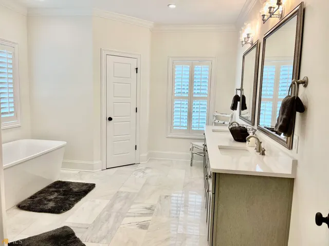 a white toilet sitting next to a bath tub and shower