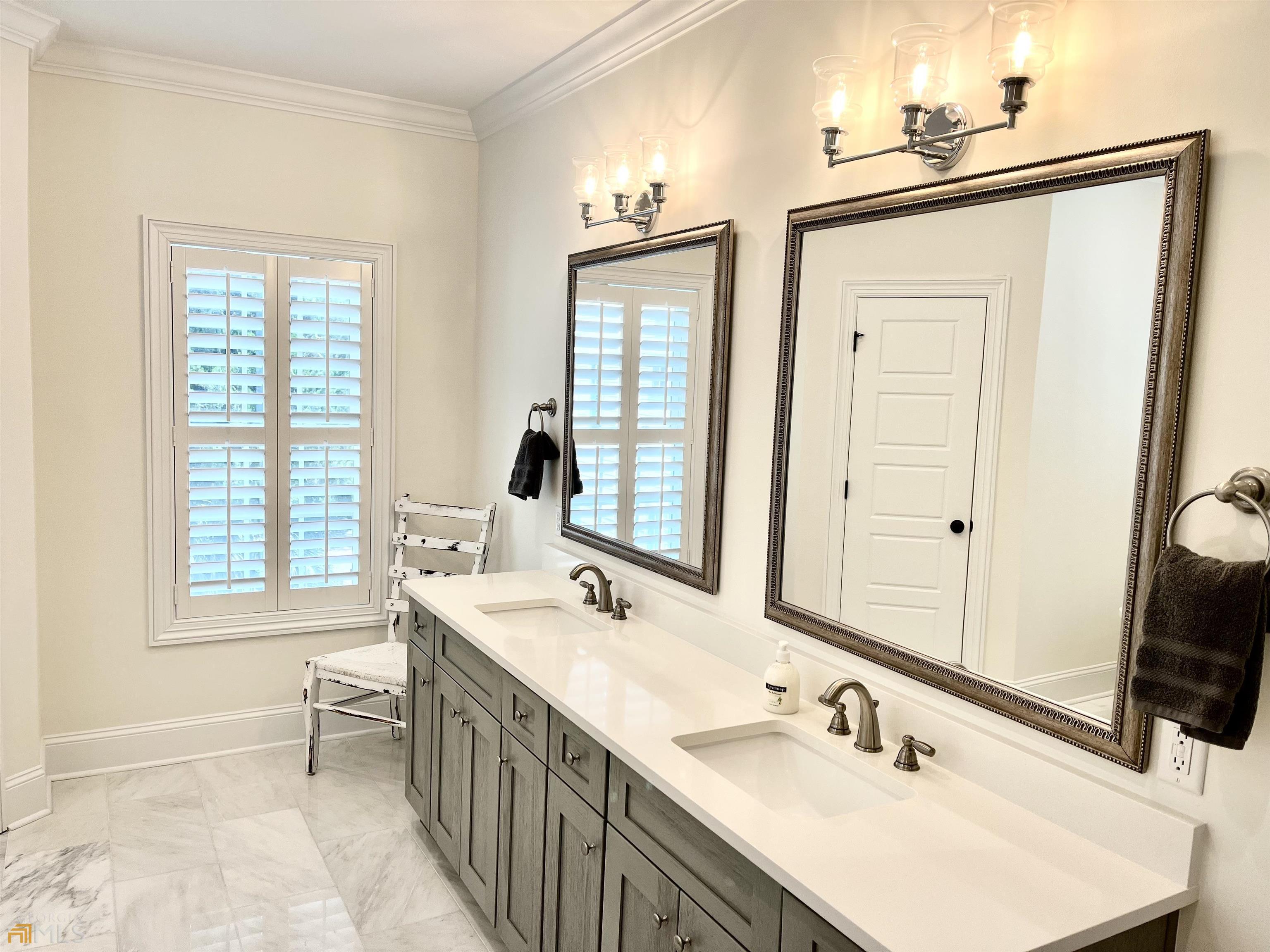 1548 Ocean Boulevard St. Simons, GA 31522 - Photo 45 of 64 a bathroom with double vanity and a mirror