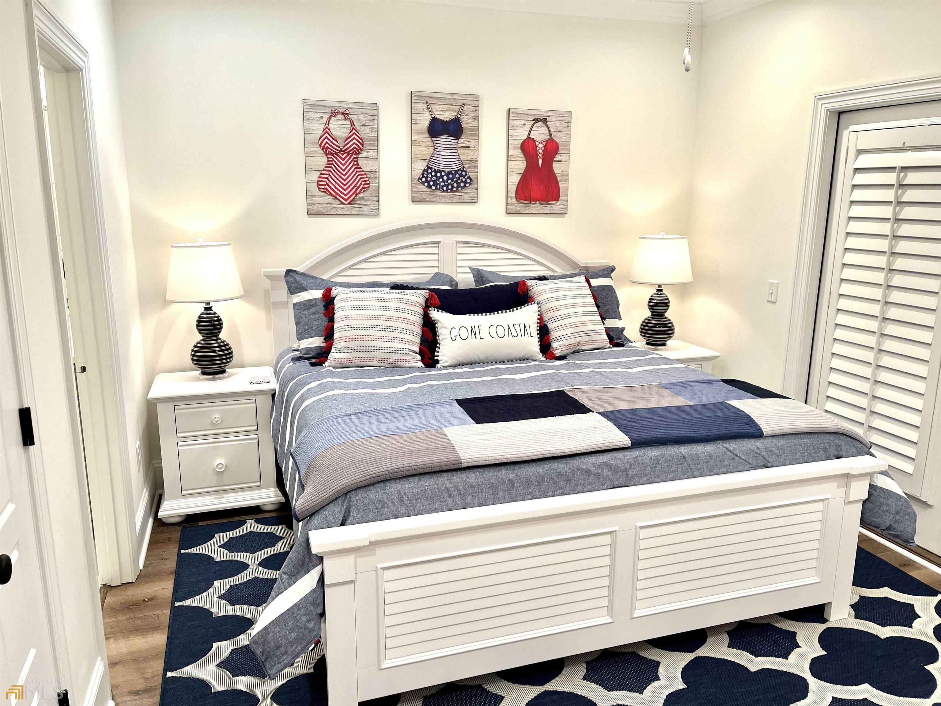 1548 Ocean Boulevard St. Simons, GA 31522 - Photo 47 of 64 a bedroom with a bed and wooden floor