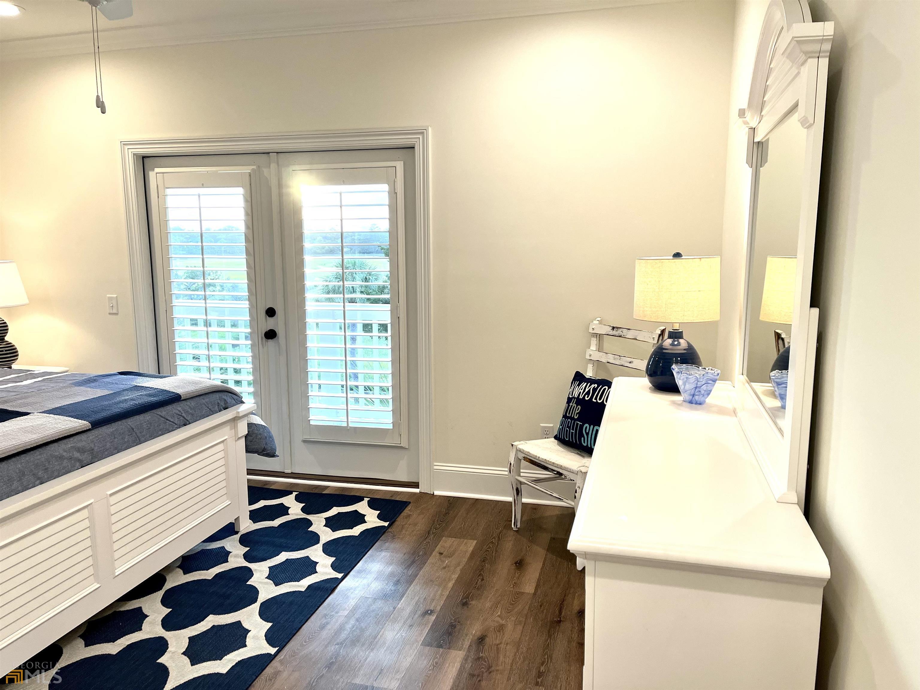 1548 Ocean Boulevard St. Simons, GA 31522 - Photo 48 of 64 a bedroom with a bed and wooden floor
