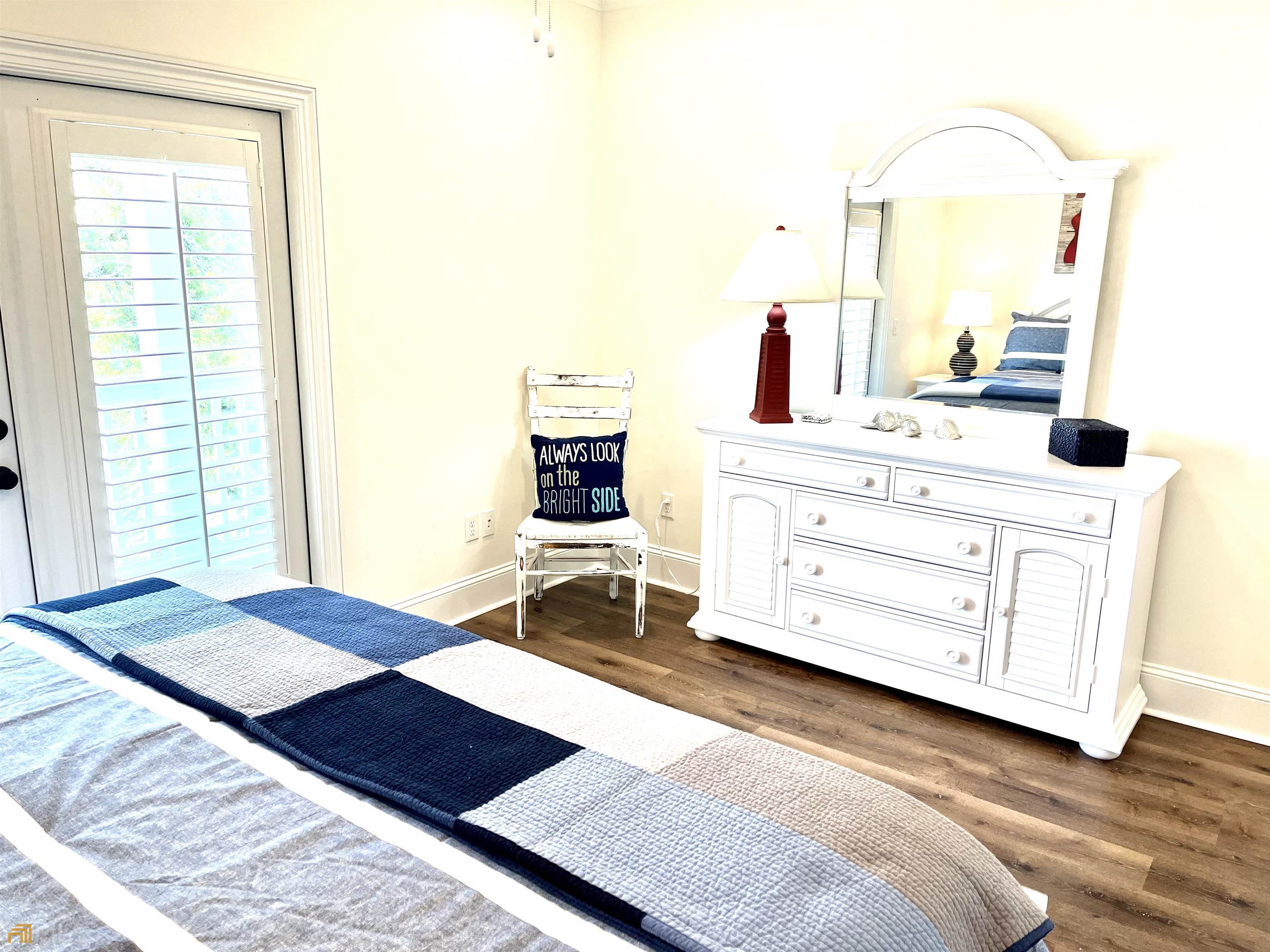 1548 Ocean Boulevard St. Simons, GA 31522 - Photo 49 of 64 a bedroom with a bed and a dresser