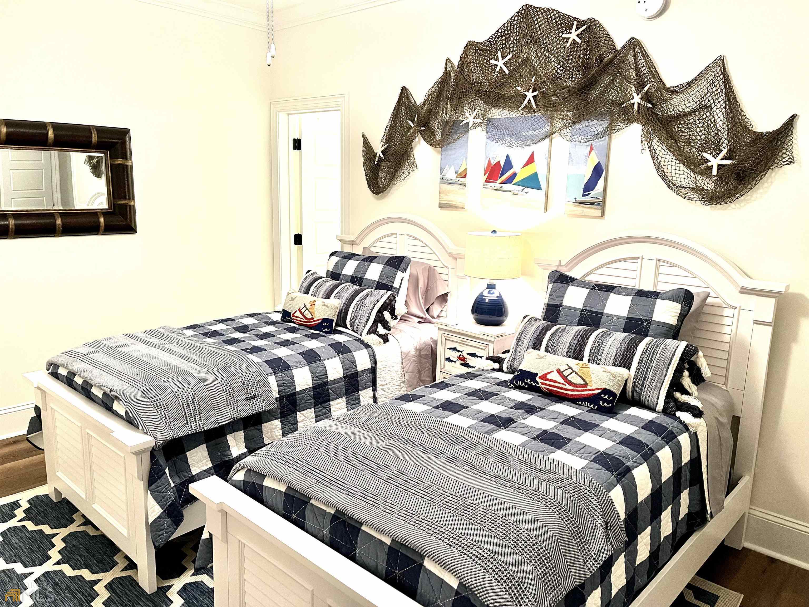 1548 Ocean Boulevard St. Simons, GA 31522 - Photo 51 of 64 a bedroom with two beds and a painting on the wall