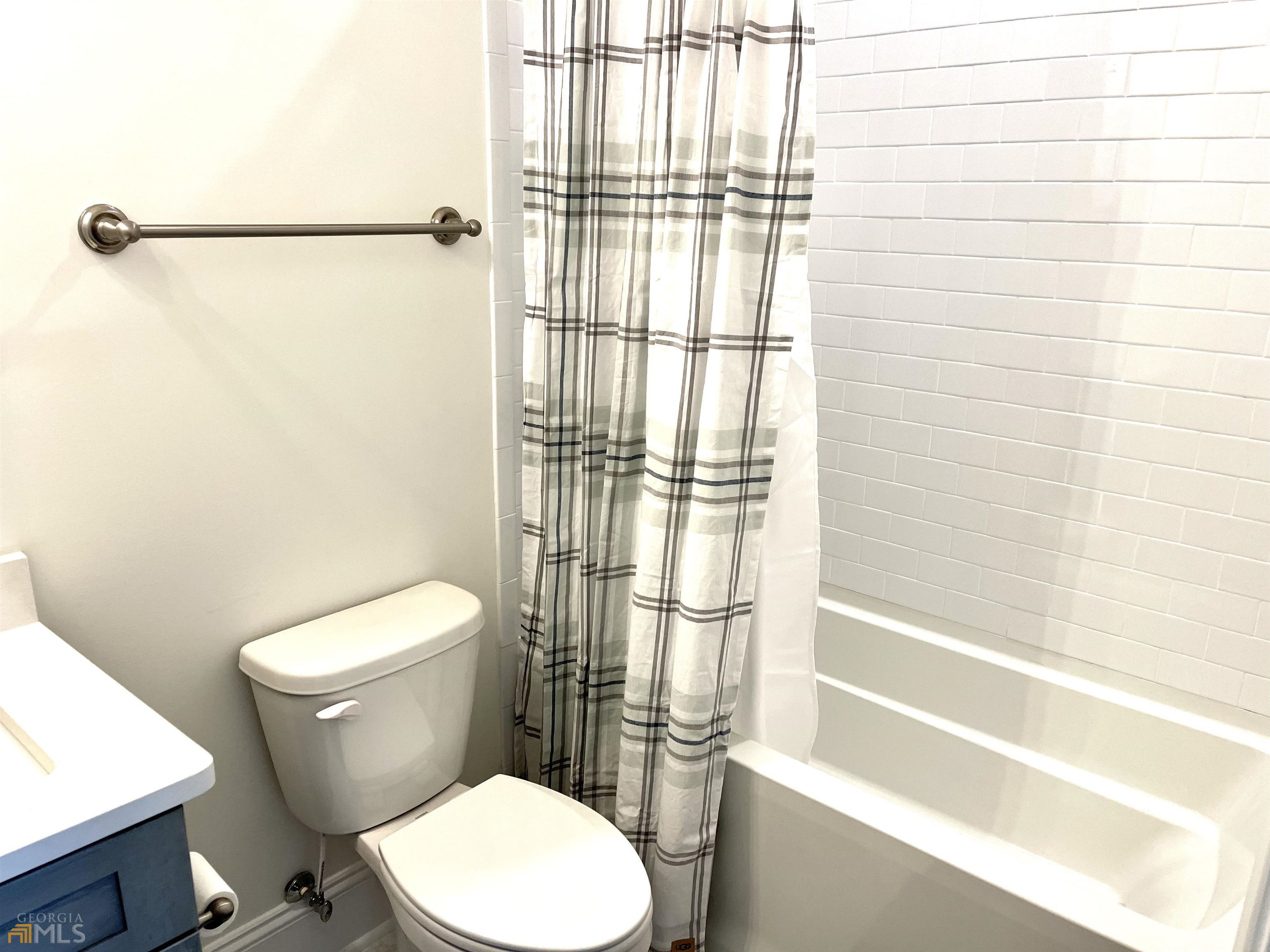 1548 Ocean Boulevard St. Simons, GA 31522 - Photo 53 of 64 a white toilet sitting next to a bath tub and shower