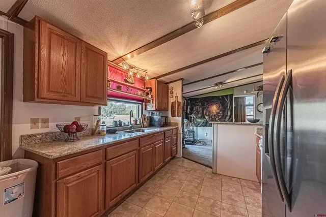 a kitchen with stainless steel appliances granite countertop a refrigerator and stove
