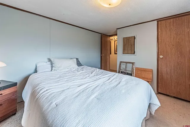 a bedroom with a bed and a table