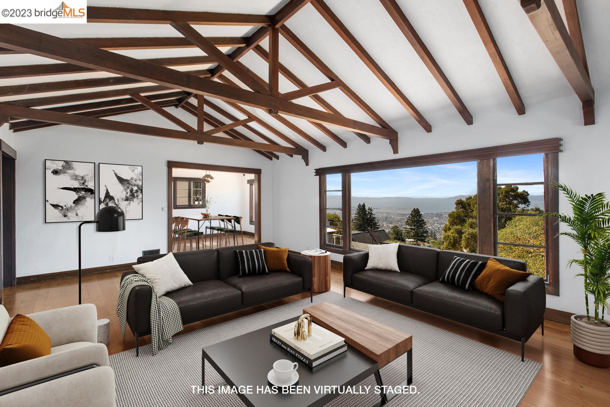 a living room with furniture and a floor to ceiling window