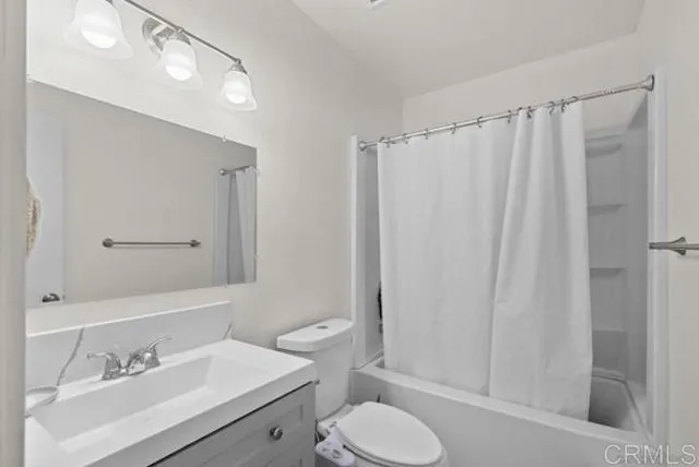 a bathroom with a sink vanity mirror and toilet