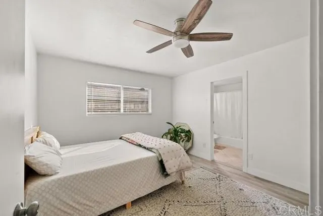 a bedroom with a large bed and a window