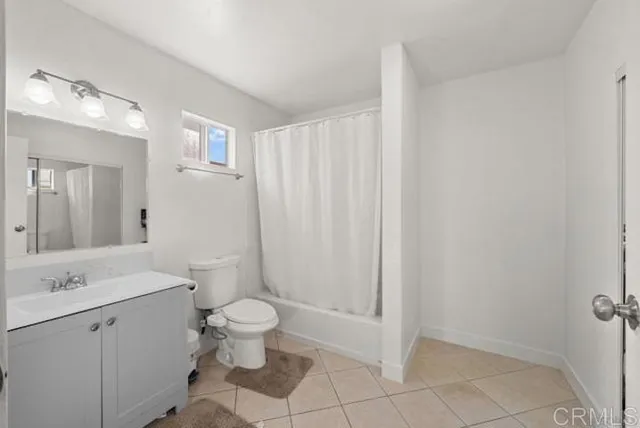 a bathroom with a toilet sink and a mirror