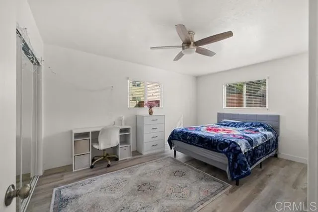 a bedroom with a bed a table and chair